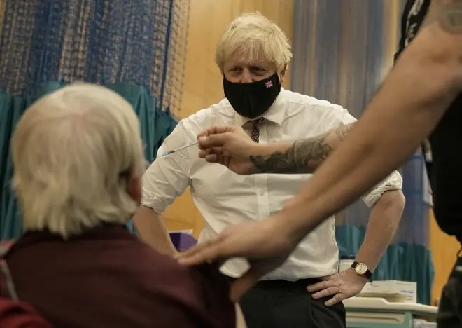 Boris Johnson watches 88-year-old Nitza Sarner receive a Covid booster vaccine. Some 10 million people have now had a booster, the PM announced.