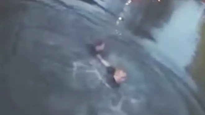 Body-cam footage shows the moment the police officer dived into the canal