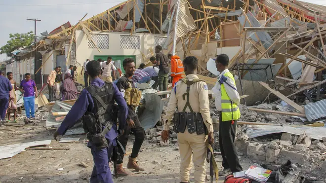 Security forces and rescue workers search for bodies at the scene of a blast in Mogadishu