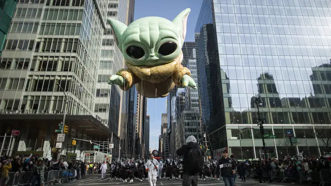 Baby Yoda, also known as the Grogu balloon, floats along Sixth Avenue during the Macy’s Thanksgiving Day Parade in New York