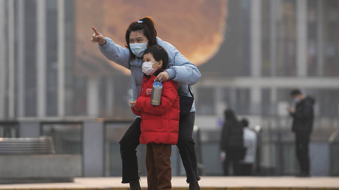 A woman and child wearing face masks in Beijing