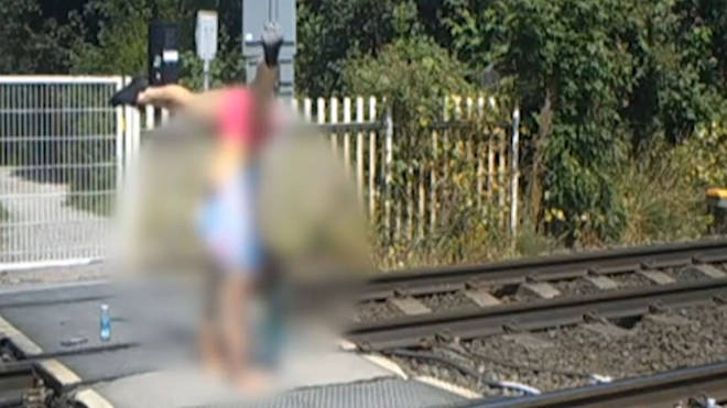 Two teenage girls were spotted doing hand stands on a train track