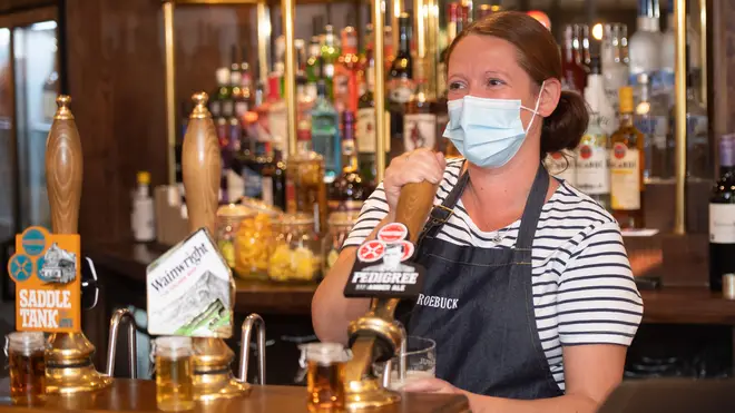 A barmaid pouring a pint