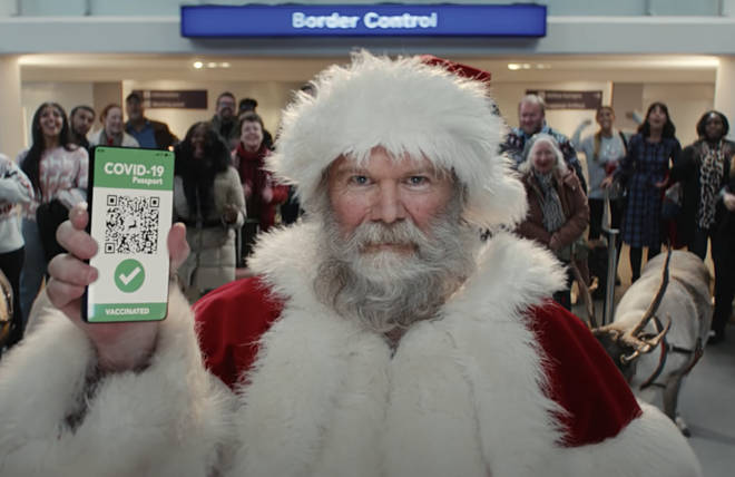 Santa showing his Covid vaccine passport in the ad. 