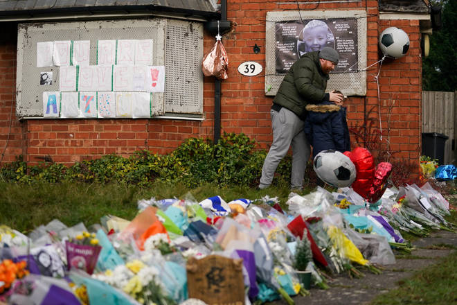 People gather to pay tribute to six-year-old Arthur Labinjo-Hughes outside Emma Tustin's former address in Solihull, West Midlands.