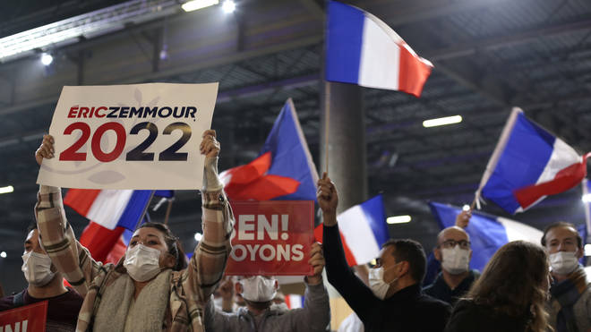 Supporters of French presidential candidate Eric Zemmour wave posters and flags during the candidate’s first rally