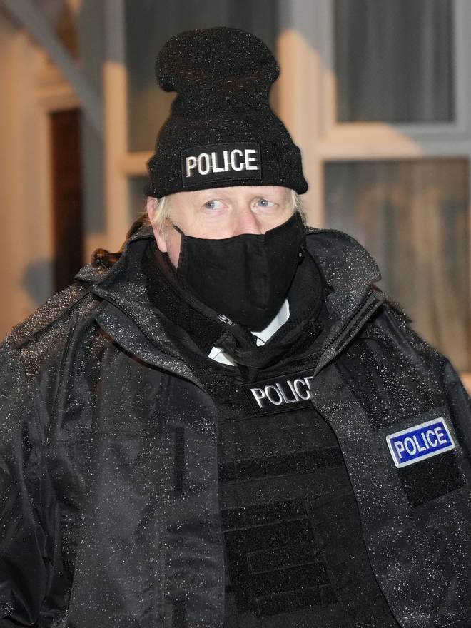 Boris Johnson put on a beanie hat, stab vest and police jacket as he joined officers on raids this morning