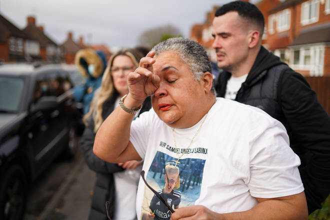 Arthur's grandmother Madeleine Halcrow cries as balloons are released in his memory