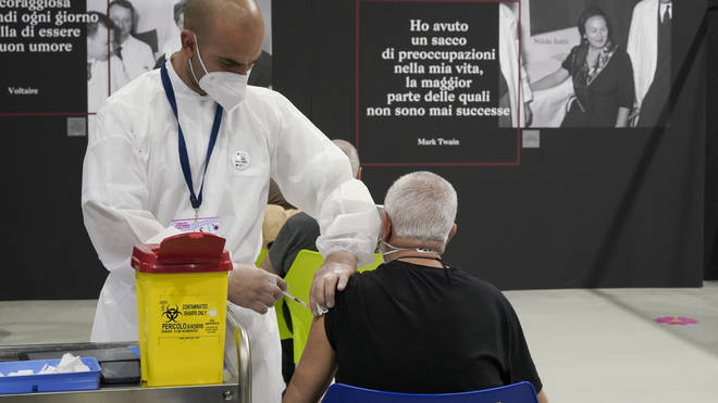 A man receives a dose of the Pfizer vaccine in Rome