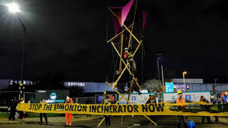 Activists hold up a banner at one of the incinerator entrances