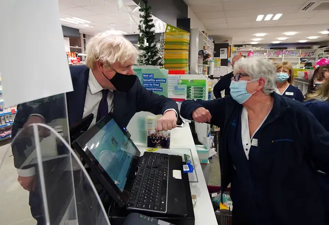 Prime Minister Boris Johnson meets staff during a visit to a pharmacy in the North Shropshire constituency ahead of the upcoming by-election