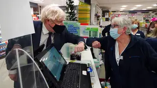 Prime Minister Boris Johnson meets staff during a visit to a pharmacy in the North Shropshire constituency ahead of the upcoming by-election