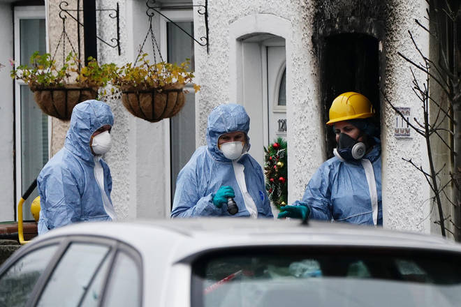 Forensic investigators at the scene in Collingwood Road, Sutton, south London, where two sets of twin boys, aged three and four, died in a devastating house fire on Thursday.