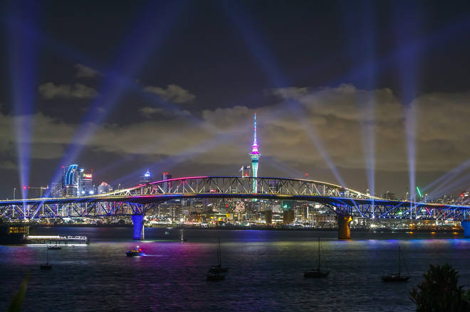 A light show from the Skytower and harbour bridge during Auckland New Year's Eve celebration