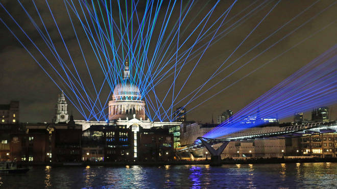 Lasers illuminate the night sky over St Paul's cathedral.