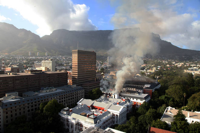 A general view of a building on fire at the South African Parliament precinct in Cape Town.