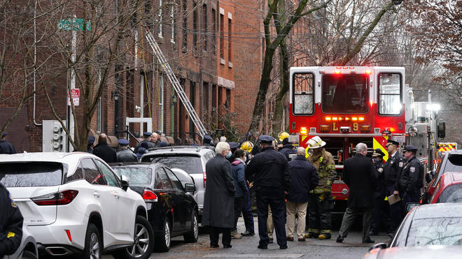 Firefighters work at the scene of a deadly house fire in the Fairmount neighbourhood of Philadelphia
