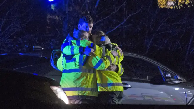 Members of the ambulance service console each other at the scene