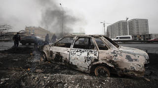 A car which was burned after clashes in Almaty