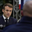 France’s President Emmanuel Macron listens to a gendarme (Daniel Cole/PA)