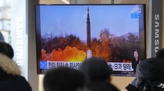 People watch a TV showing an image of North Korea’s missile launch during a news program at the Seoul Railway Station in Seoul