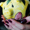 Someone holding a piggy bank