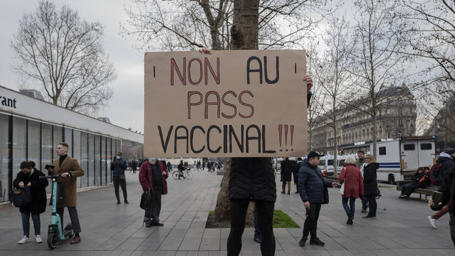 A demonstrator holds a placard that reads ‘No to vaccine pass’ during a rally in Paris, France