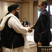 Special representative for Afghanistan Nigel Casey, right, shakes hands with Taliban representative Amir Khan Muttaqi, centre, ahead of a meeting in Oslo, Norway