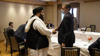 Special representative for Afghanistan Nigel Casey, right, shakes hands with Taliban representative Amir Khan Muttaqi, centre, ahead of a meeting in Oslo, Norway