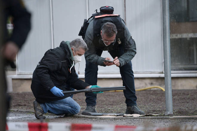 Police examine a weapon at the scene