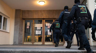 Police enter the building at the University of Heidelberg, where the shootings took place