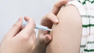 Someone receiving a vaccine jab
