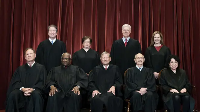 Members of the Supreme Court pose for a group photo at the Supreme Court in Washington (Erin Schaff/AP)