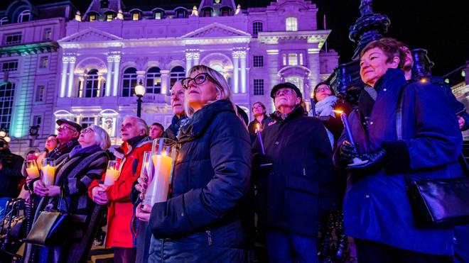 Holocaust survivors and their families watched Piccadilly Lights from the ground, seeing their portraits and lighting their own candles.