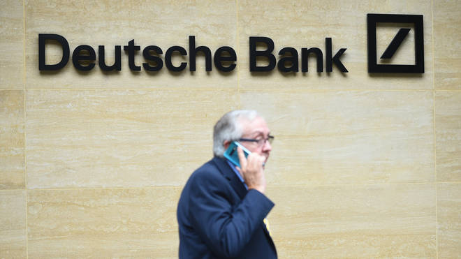 A man on his mobile phone outside the London office of Deutsche Bank