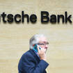 A man on his mobile phone outside the London office of Deutsche Bank