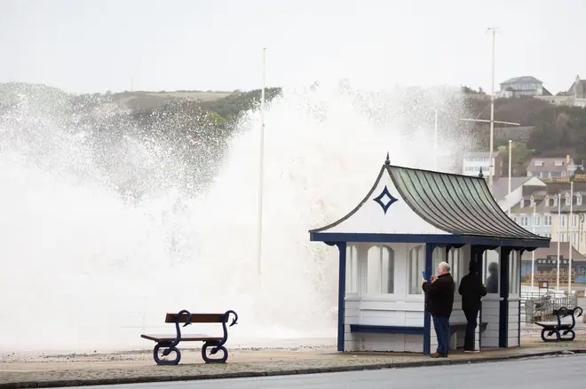 Storm Eunice and rough seas bring huge crashing waves along Aberystwyth promenade.