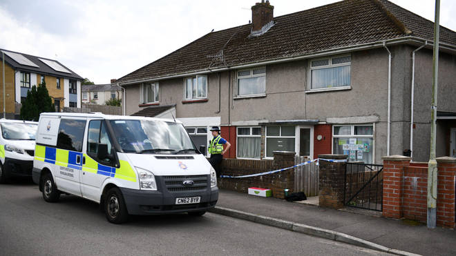 Police outside the family home of five-year-old Logan