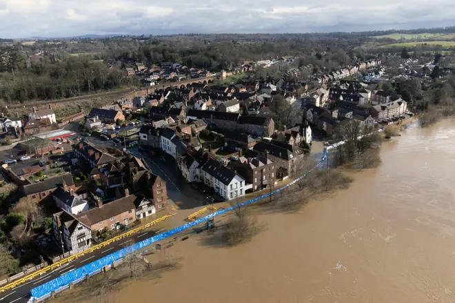 Water begins to spill behind flood defences along the River Severn at Bewdley in Worcestershire.