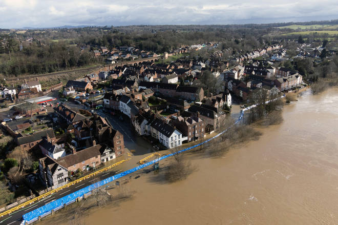 Water begins to spill behind flood defences along the River Severn at Bewdley in Worcestershire.