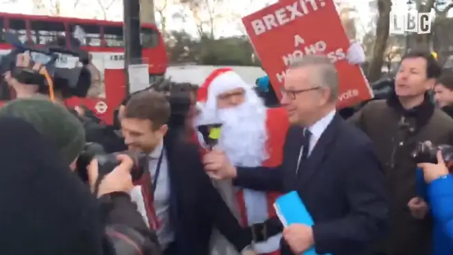 Santa Claus interrupted Michael Gove outside Parliament