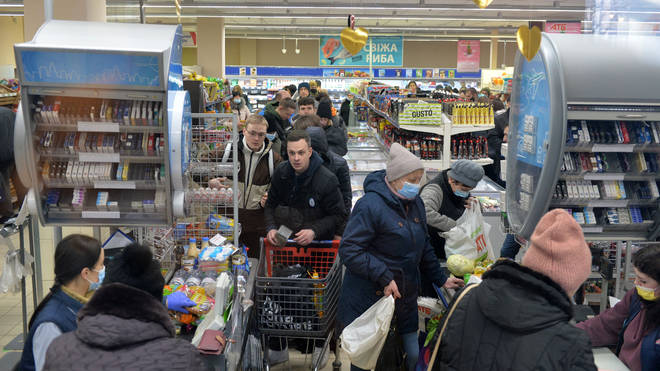 Ukrainians rush to buy supplies at a supermarket in Kharkiv - just 40km from the Russian border