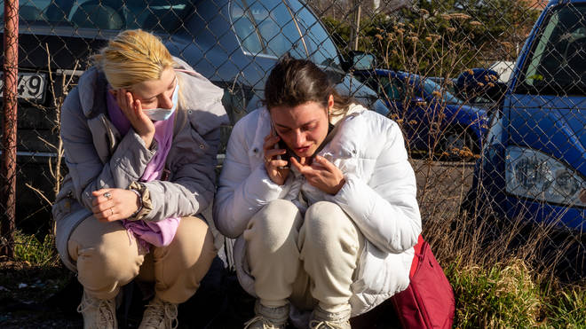 Women cry as they cross the Polish border after fleeing Ukraine
