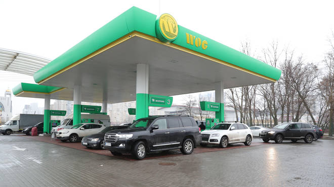 Vehicles queue up to fill gasoline at a gas station in Kiev