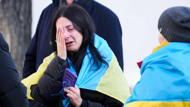Olga Lietnieva cries after hearing from family in Ukraine