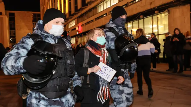 Riot police detain a demonstrator during anti-war protest in Pushkin Square