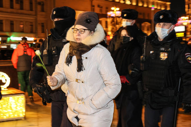 Riot police detain a demonstrator during anti-war protest in Pushkin Square