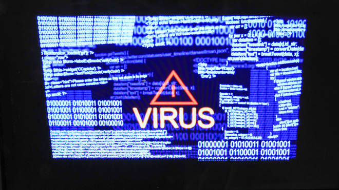 A laptop screen showing a virus warning