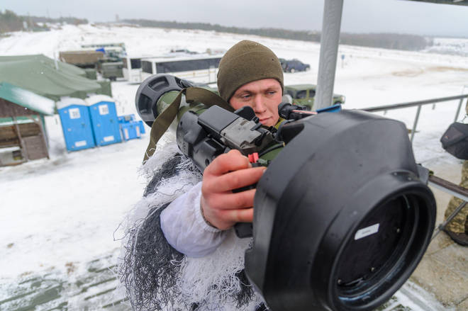 A Ukrainian solider demonstrates the use of one of the NLAW launchers