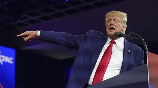 Donald Trump speaks while gesturing